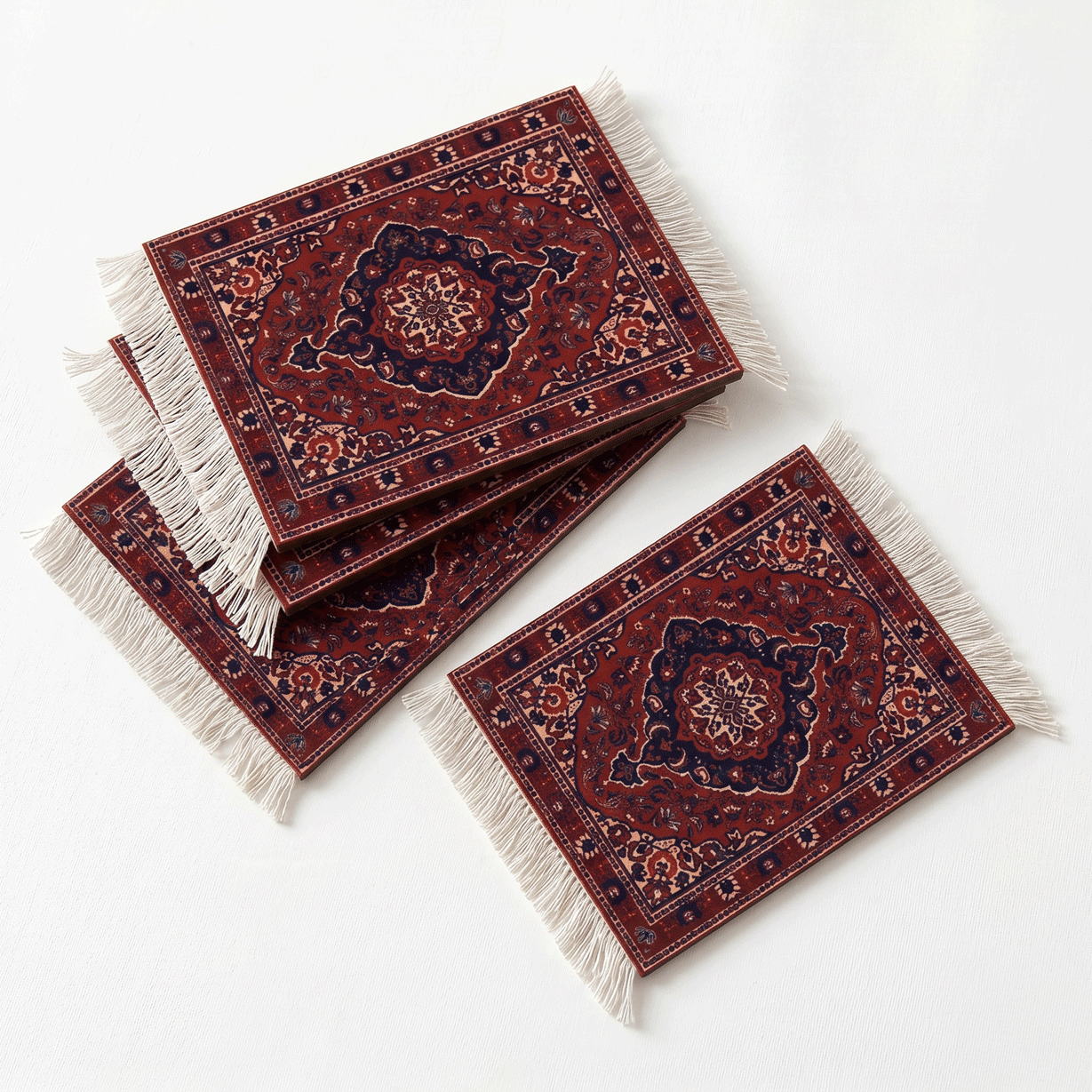 Three decorative rugs with intricate patterns and fringes on a white background